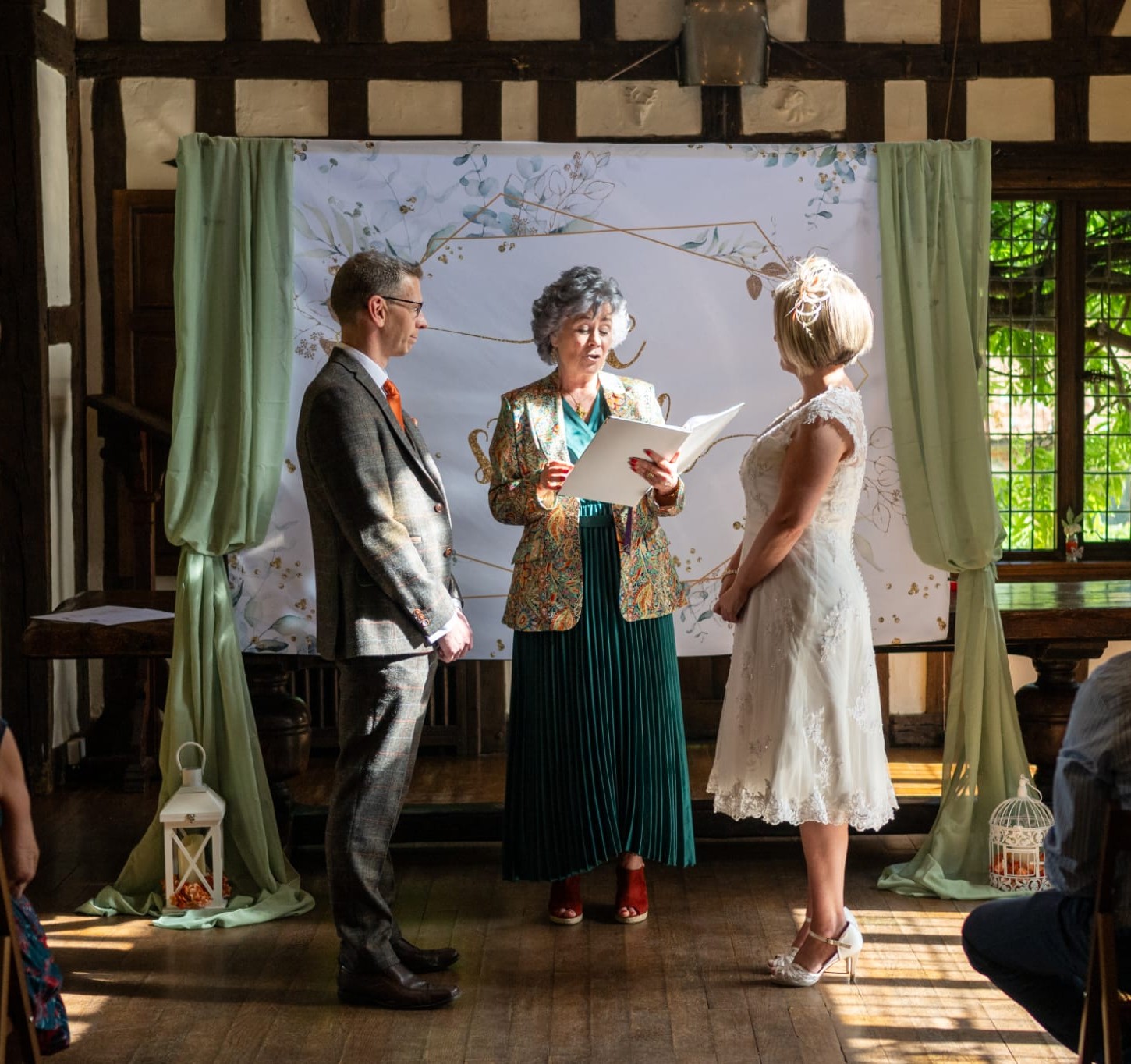 Suffolk wedding celebrant standing between the couple renewing their vows